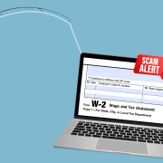 laptop with tax scam alert on fishing hook